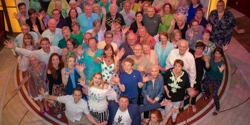 Passengers doing jazz hands for a group photo on Seth's Big Fat Broadway Cruises