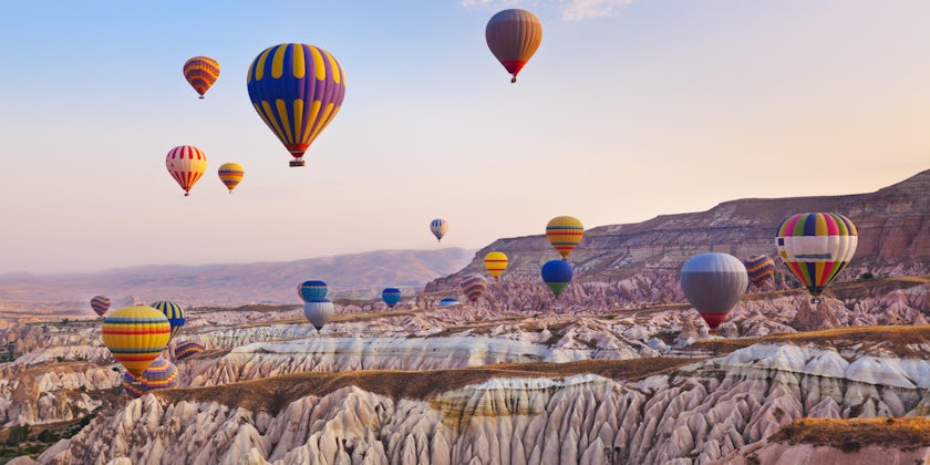 Landscape of Cappadocia, Turkey with lots of hot air balloons in the air