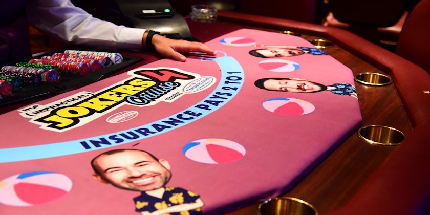 Close-up shot of a Jokers-themed poker table on Impractical Jokers Cruise 4