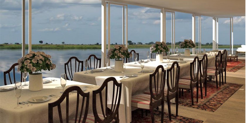 Interior of a restaurant on African Dream, with river views in the background