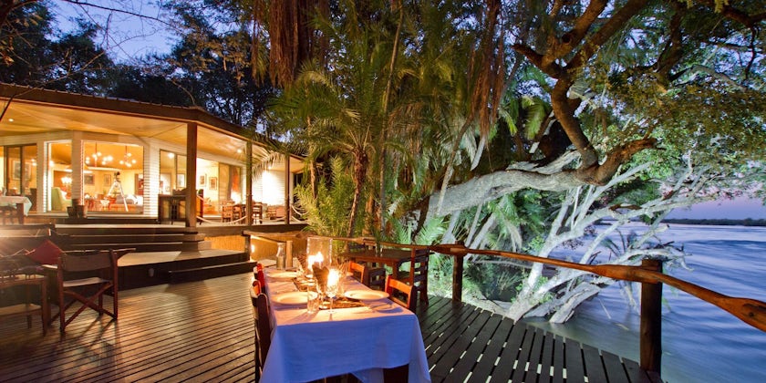 Exterior shot of al fresco dining space at night, at the luxury safari lodge in Namibia