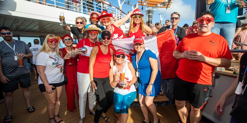 Passengers in matching Canadian outfits on the Ultimate Disco Cruise