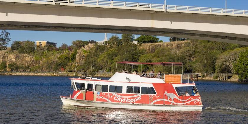 People onboard the free CityHopper ferry in Brisbane during daytime. The ferry service is free and runs along the Brisbane River.