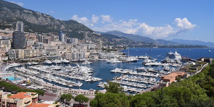 Panoramic shot of the Monaco harbor, with ships and boats docked, on a sunny day