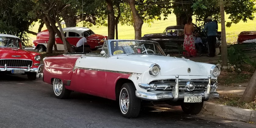 Exterior shot of a shiny red and white car in Havana, Cuba