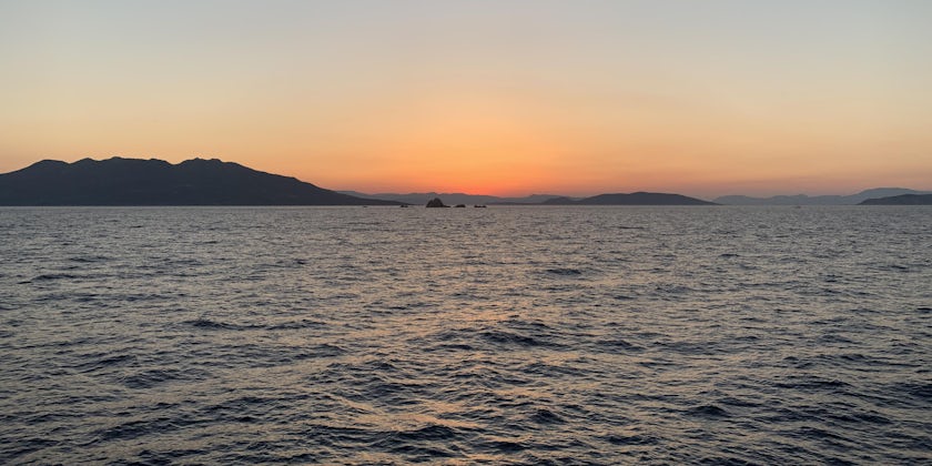 Panoramic shot of an orange Sunset over the ocean in Greece