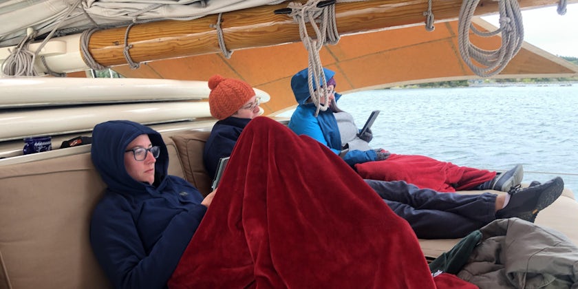 Passengers reading, relaxing and bundled up onboard Stephen Taber