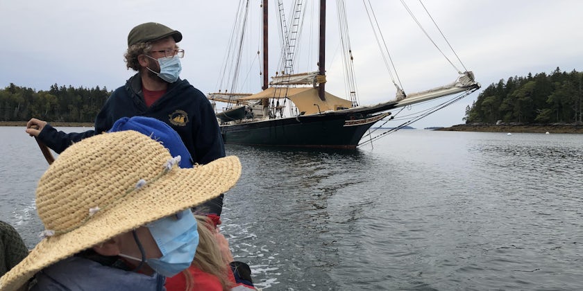 Stephen Taber's captain driving the tender boat ashore -- everyone is wearing masks