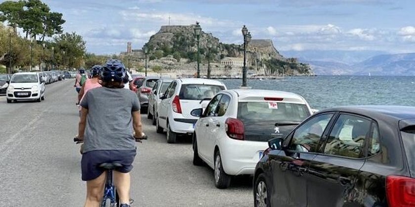 Shot of passengers riding bikes down the pier during on an e-bike excursion in Corfu