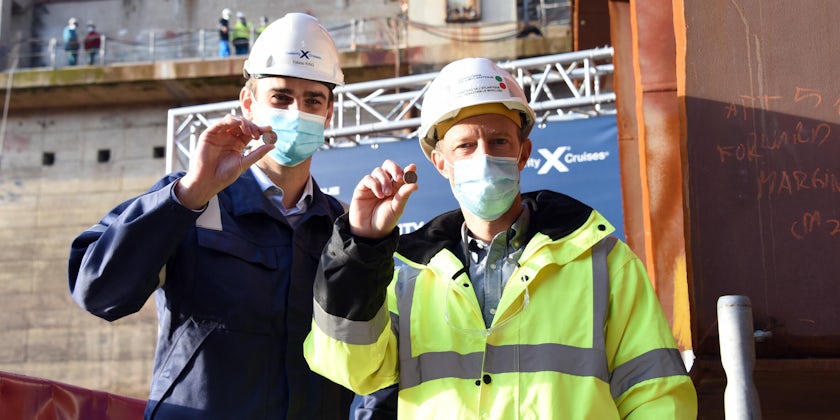 Tobias King, Celebrity Cruises' Edge Series Project Manager, and Sébastien Le Boulluec, Chantiers de l'Atlantique's Edge Series Project Manager, hold the ceremonial "good fortune" coin for Celebrity Beyond as the ship's keel is laid (Photo: Celebrity Crui