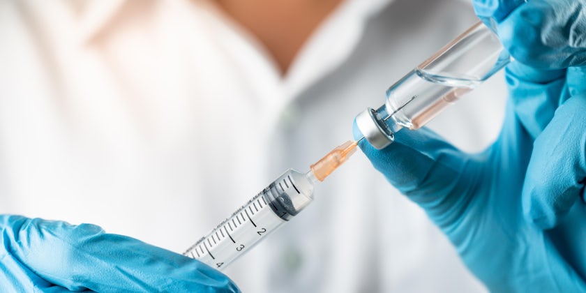Close-up shot of a COVID-19 vaccine and syringe