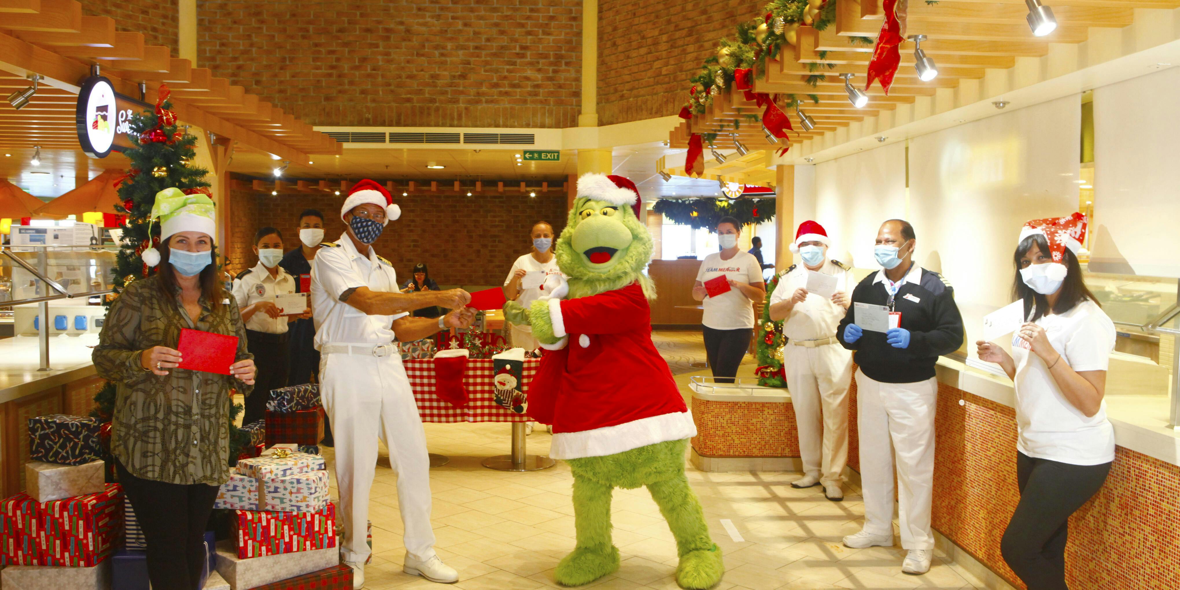 Grinch delivers holiday cards to cruise ship crew around the world