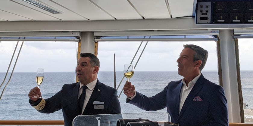Captain Theo Zakkas, and senior VP hotel operations, Brian Abel, welcoming select passengers onboard at a get together on the bridge