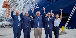 Richard Fain, center, celebrates Celebrity Cruises with team members