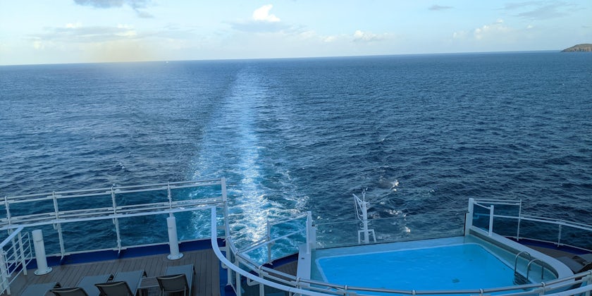 The aft pool with a wake in the background from Enchanted Princess cruise ship (Photo by Colleen McDaniel)