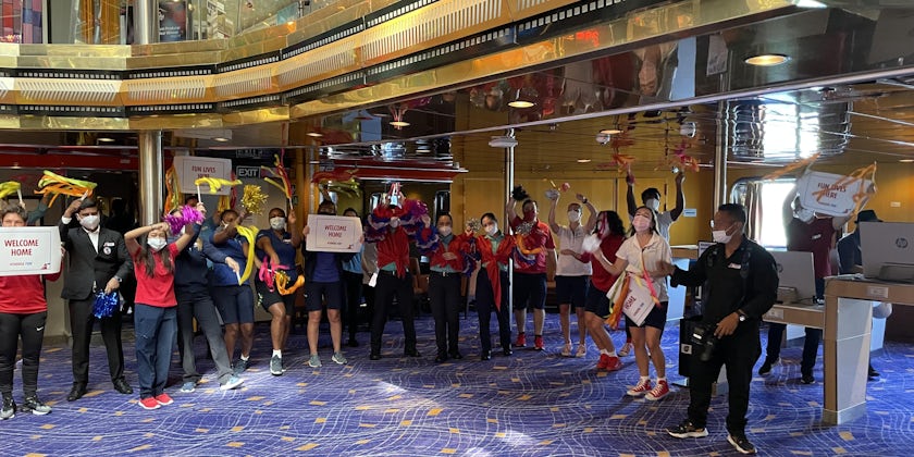 Crew welcome passengers aboard Carnival Ecstasy's final voyage (Photo: Peter Knego)