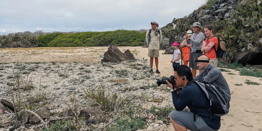 A guide and cruisers watch wildlife in the Galapagos. (Photo: Colleen McDaniel)