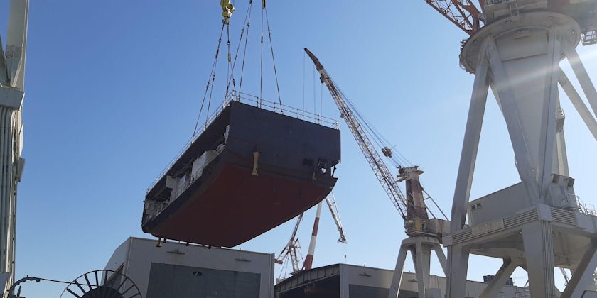 Explora II's hull being lowered into place at Fincantieri shipyard Genoa (Photo: Jeannine Williamson)