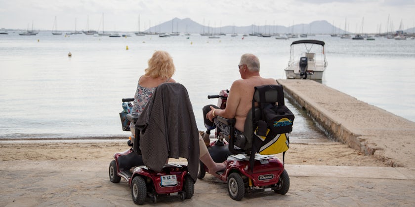 Senior couple on mobility scooters (Photo: The Art of Pics/Shutterstock)