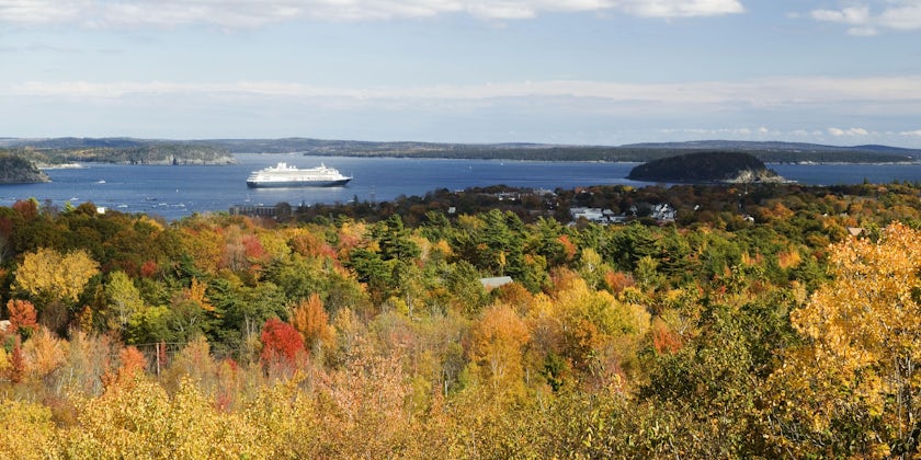 Cruise ship sailing past an autumn landscape (Photo: Joseph Sohm/Shutterstock)