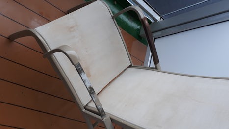 Balcony chairs with missing arms and exposed screws