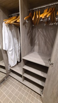 Closet with shelves and 2 robes, and our extra hangers we asked for