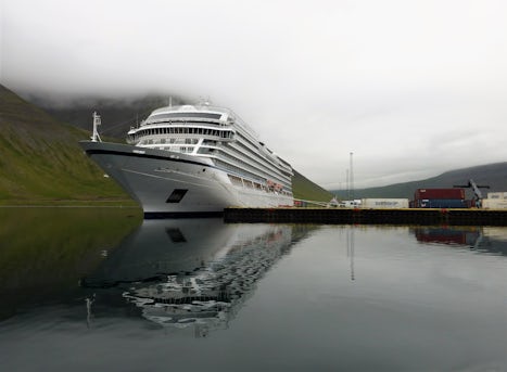 Docked in Isafjordur in a fjord, with high cliffs out the window. Water was like glass. Said "WOW!" when I pulled the drapes and looked out (starboard side).