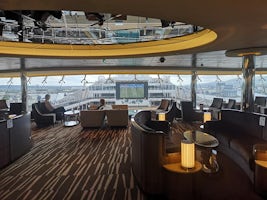 Sky lounge is open to everyone and has good view over the middle of the ship. Serve snacks at certain times of the day as well as drinks. Great for seeing the big pool screen if you get the forward facing chairs.