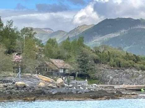 A typical Norwegian Fjord view with mountains, waterfalls, small villages and farms.