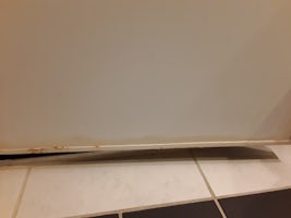 Built up gunk on bottom of inside of bathroom door