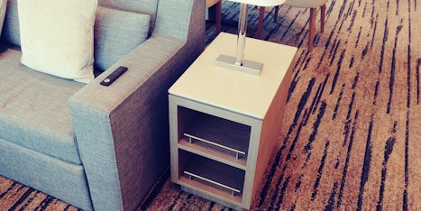 End table with lamp.  They should have power outlets on this lamp bases to plug in devices.
