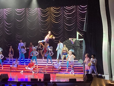 Acrobats, basketball dunking, singers, dancers at the show at night