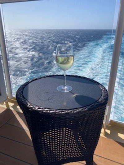 A glass of wine on an aft-facing balcony is my favorite part of cruising.