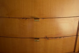 Peeling & cracked wood veneer in cabin sitting area.