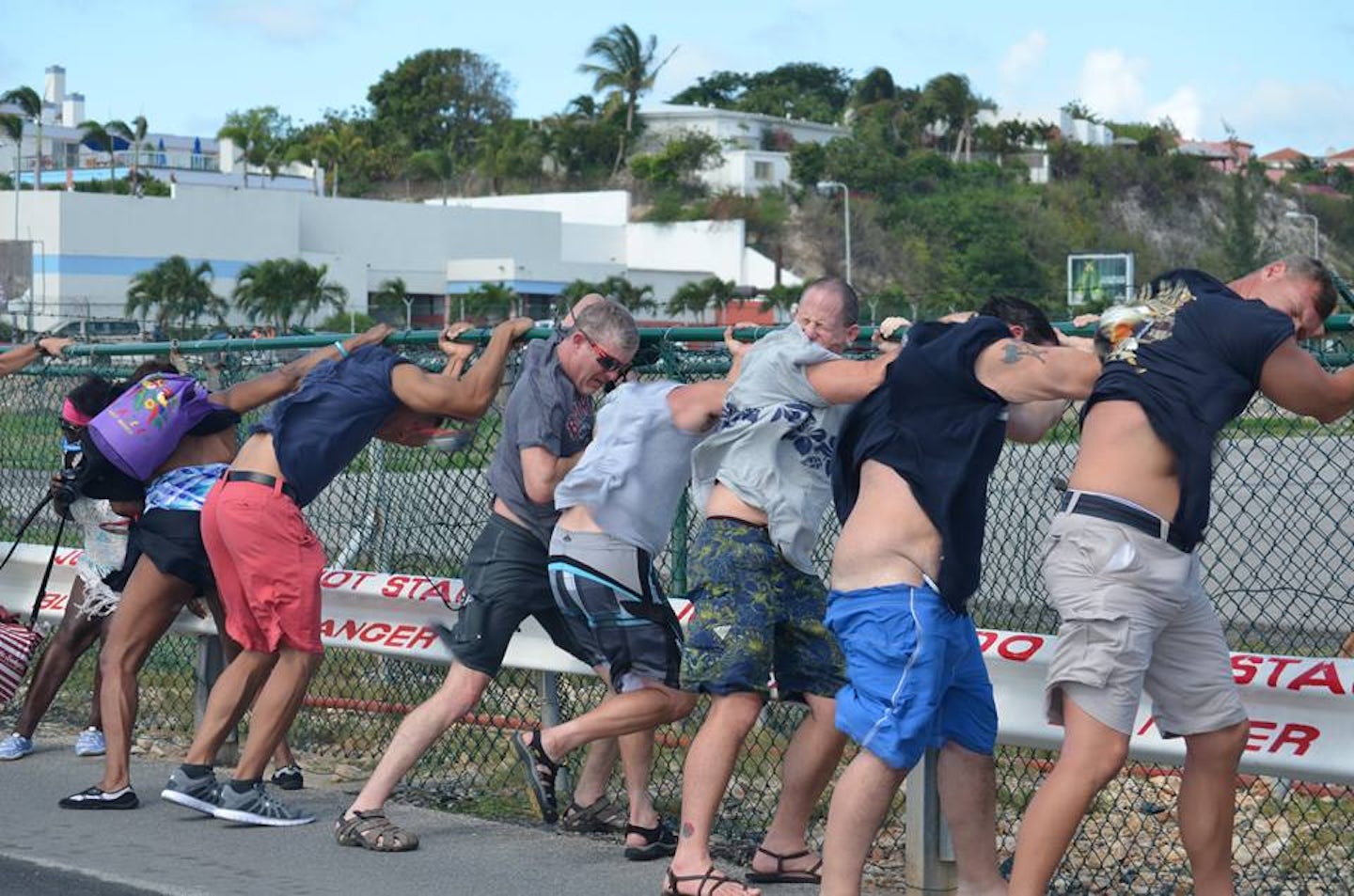 fence surfing at Maho beach St Maarten