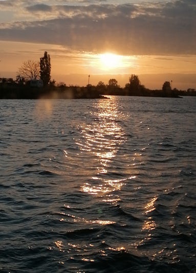 Sunset seen from boat as it cruises towards Amsterdam