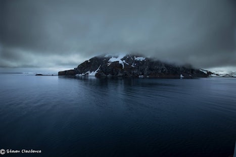 An Antarctic island reflection sets the mood.