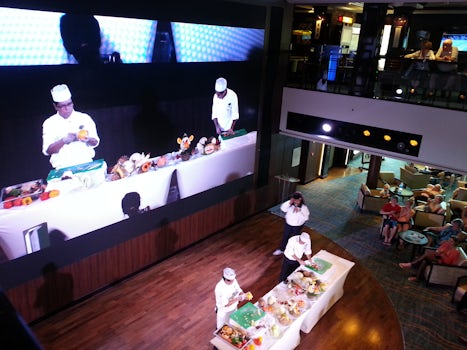 Atrium vegetable carving, also being shown on the gigantic LED screen.
