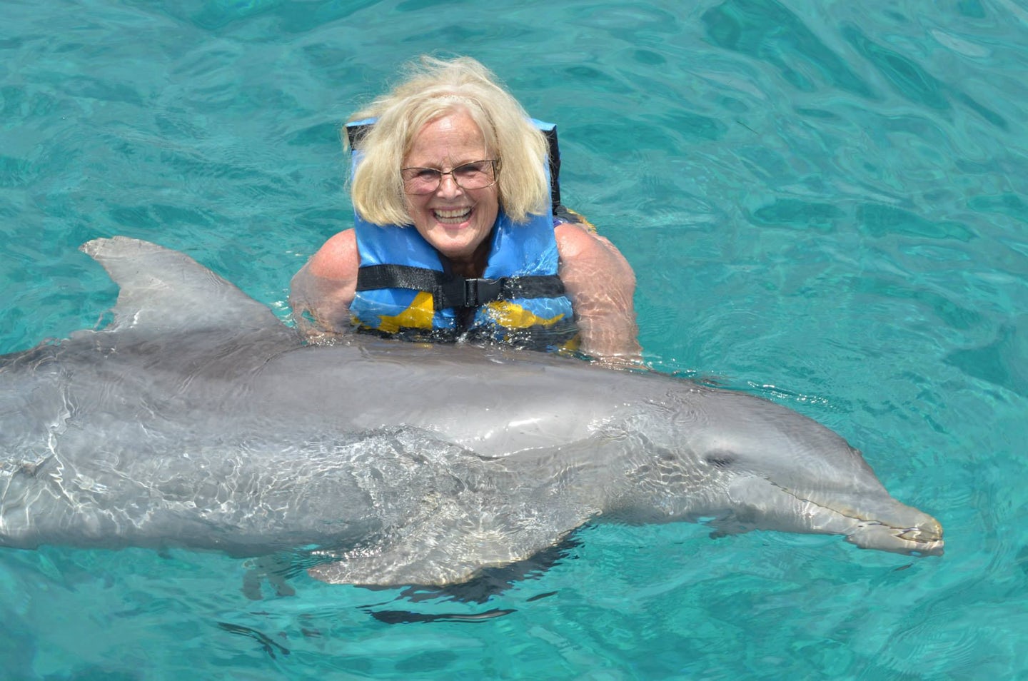 Mom swimming with the dolphins in Cozumel, Mexico at Chankanaab Adventure B
