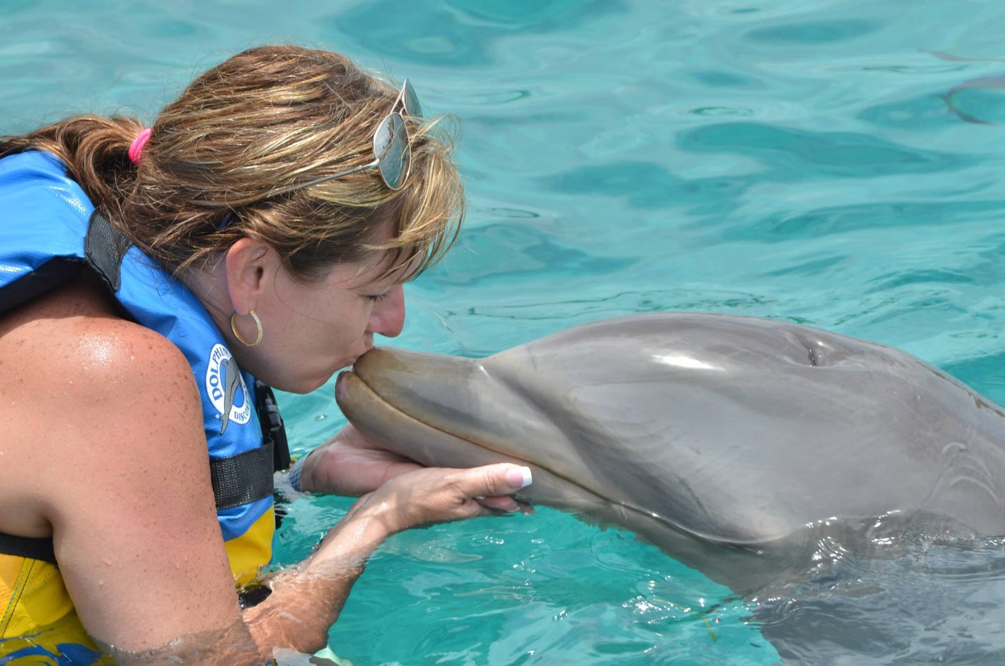 Sonja swimming with the dolphins in Cozumel, Mexico at Chankanaab Adventure