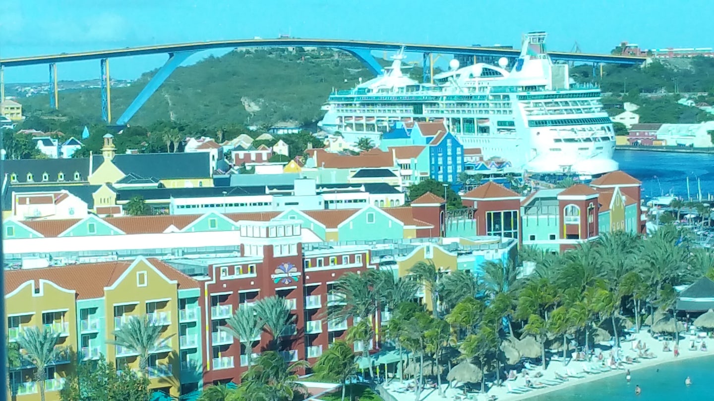 View from ship of colorful port & another docked cruise ship.