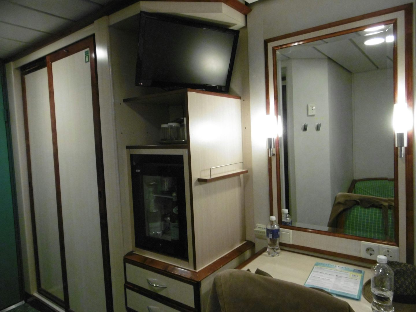Inside cabin level 6. Wardrobe, tv, mini bar and dressing table. There was 2 plugs - one USA and one British.