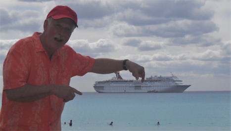 Playing in the water with my toy replica of the Carnival Ecstasy.