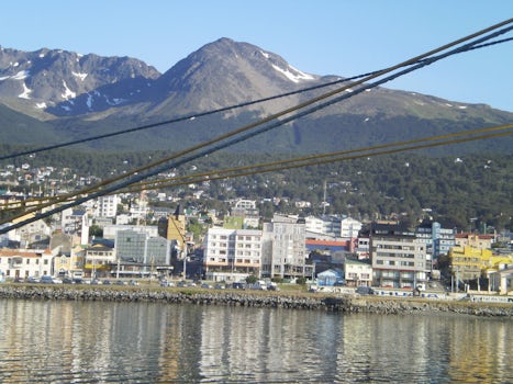 entering Ushaia harbor with mountains towering  over the town at the end of the world
