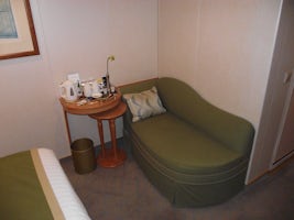Inside Cabin C162, Deck 9. Chaise and tea making facilities.