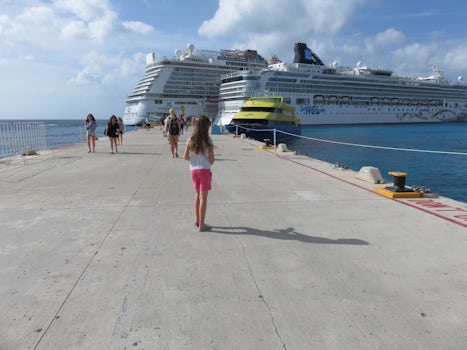 Granddaughter walking back to the ship in Cozumel.   Two Norwegian Ships together.