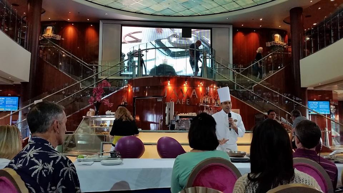 Watching a cooking demonstration in the atrium of the ship.