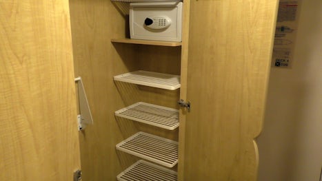 The safe and shelves in the wardrobe of the cabin.