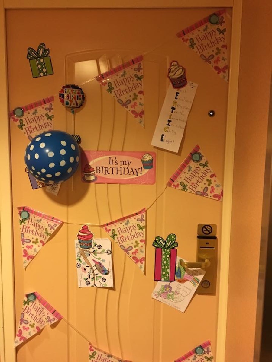 Outside cabin door decorated with magnets and decor.