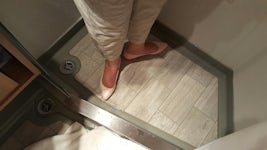 The tiny shower in an Azamara Quest suite.  These are size 6 feet.
